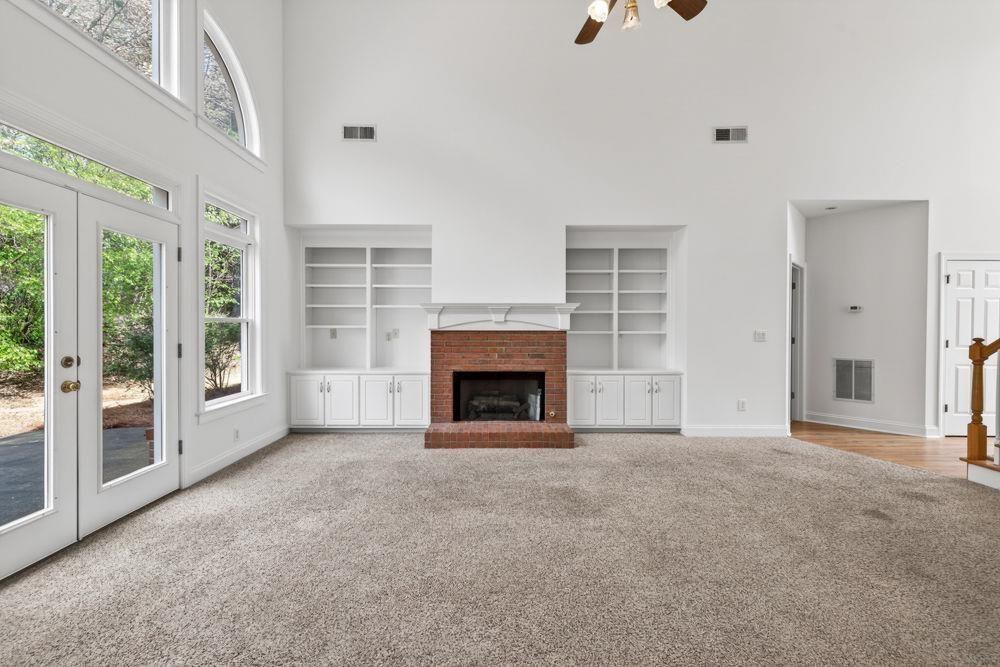 7512 Fieldstone Way Monroe, GA 30656 - Photo 24 of 49 a view of an empty room with a fireplace and a window