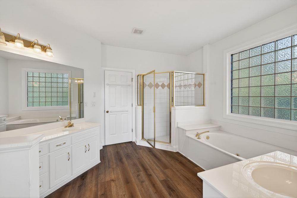 7512 Fieldstone Way Monroe, GA 30656 - Photo 29 of 49 a spacious bathroom with a double vanity sink a mirror and a bathtub