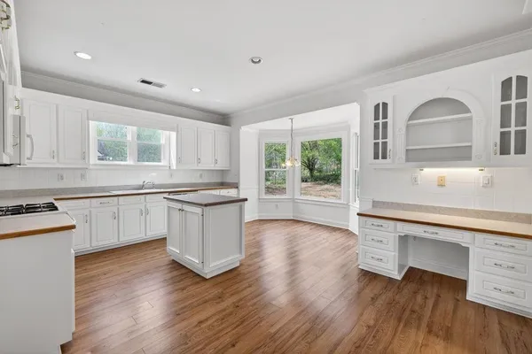 a kitchen with granite countertop white cabinets and white appliances