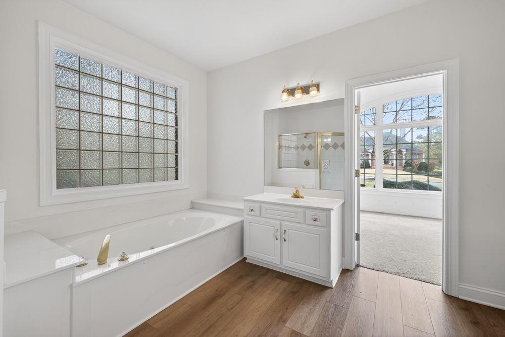 7512 Fieldstone Way Monroe, GA 30656 - Photo 8 of 49 a bathroom with a tub sink and mirror