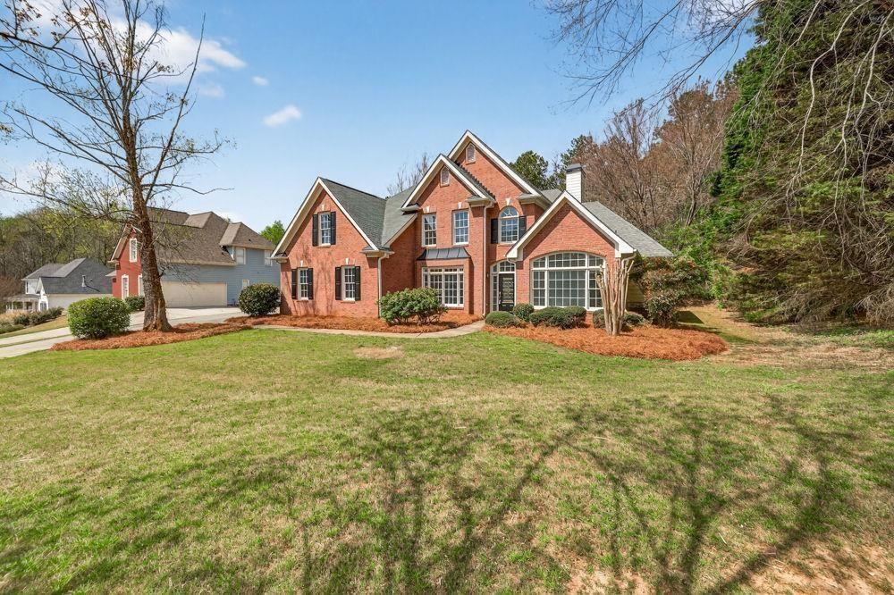 7512 Fieldstone Way Monroe, GA 30656 - Photo 9 of 49 a view of house that has a small yard and large trees