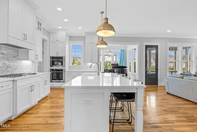 a view of a hallway with wooden floor and entryway