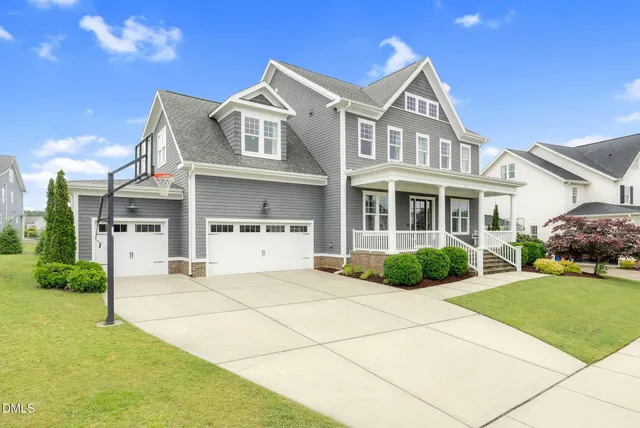 a view of a dining room with furniture wooden floor and a chandelier