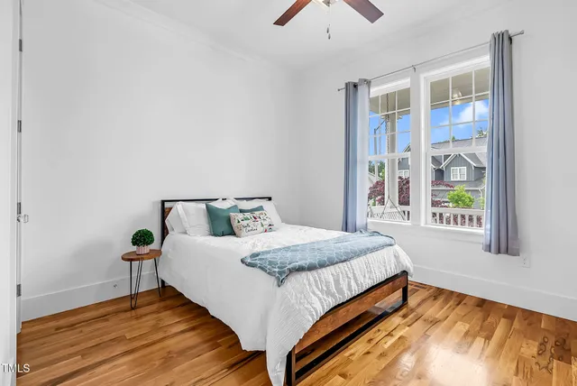 a view of a hallway with wooden floor and entryway