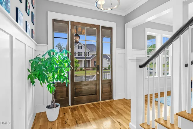 a living room with furniture a fireplace a flat screen tv and potted plant