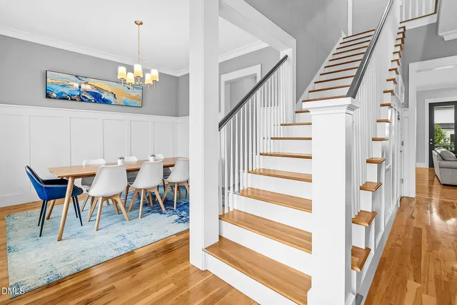 a living room with furniture kitchen view and a large window