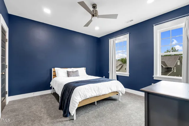 a living room with furniture a projector and screen