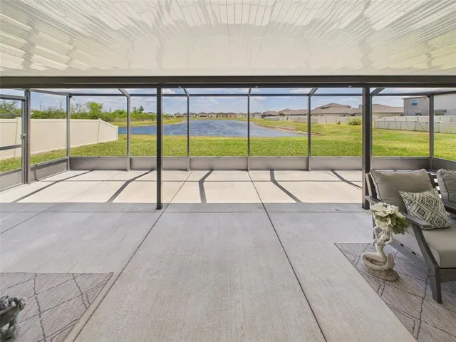 a view of an empty room and floor to ceiling window