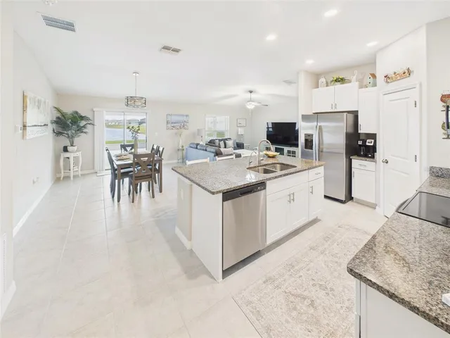 a kitchen with refrigerator and cabinets