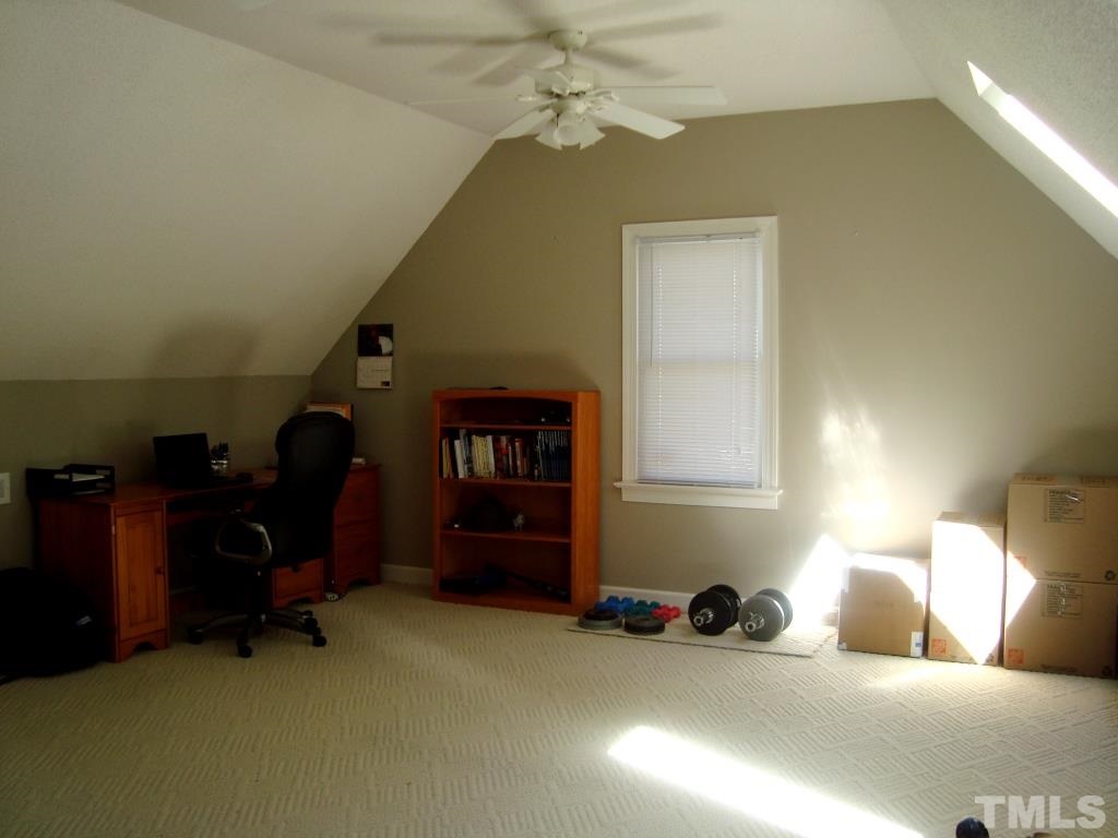 1412 Shadowview Court Raleigh, NC 27614 - Photo 22 of 25 a bedroom with a bed and a chandelier