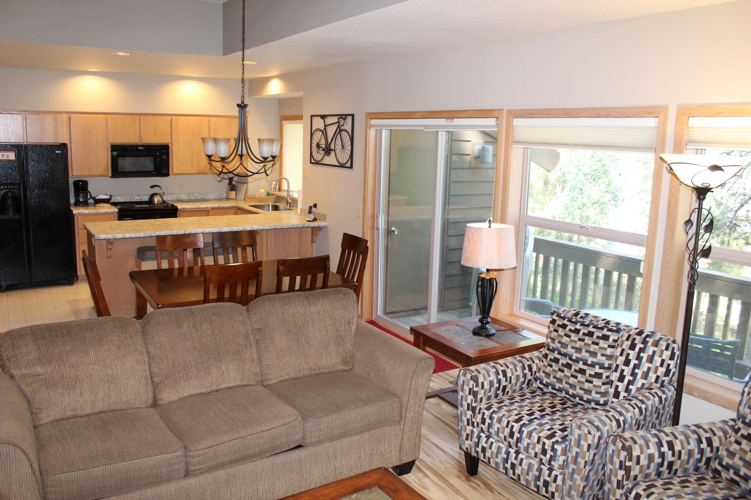 57407-44c Beaver Ridge Loop Sunriver, OR 97707 - Photo 6 of 24 a living room with furniture a flat screen tv and floor to ceiling window