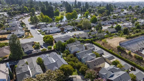 an aerial view of residential houses with outdoor space