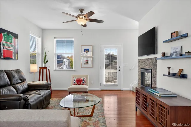 a living room with furniture a fireplace and a flat screen tv
