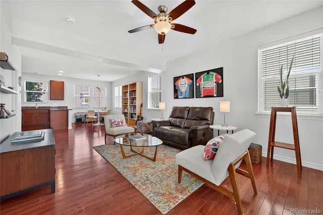 a living room with fireplace furniture and a wooden floor