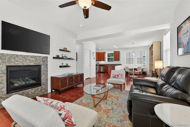 a living room with furniture a flat screen tv and a fireplace