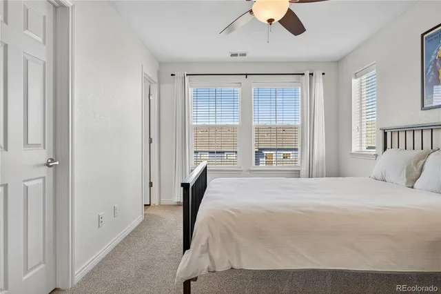 a bedroom with a large bed and a large window