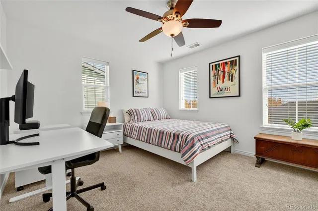 a bedroom with a bed and a desk