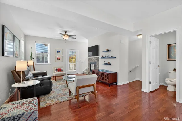 a living room with furniture and wooden floor