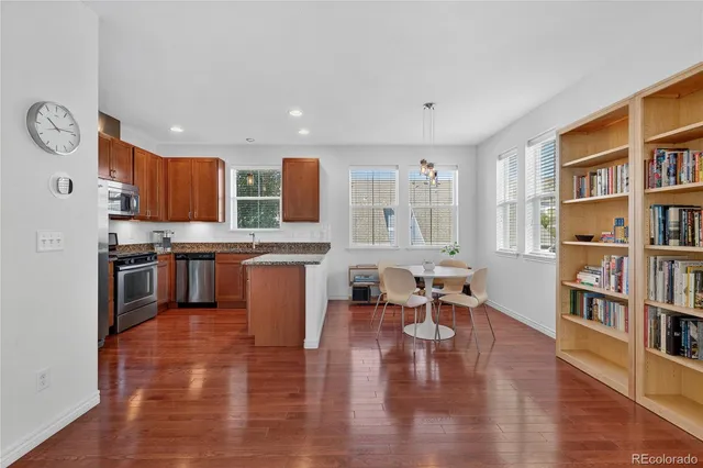 a large open kitchen with stainless steel appliances granite countertop a stove and a refrigerator