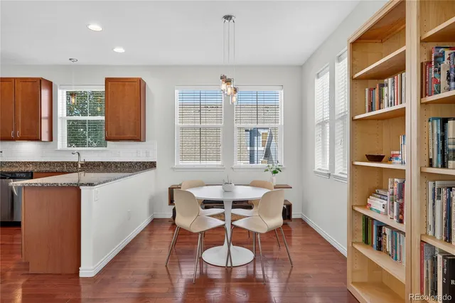 a dining room with furniture and a book shelf
