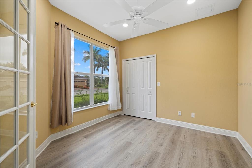 4331 Turnberry Circle North Port, FL 34288 - Photo 3 of 25 an empty room with wooden floor and windows