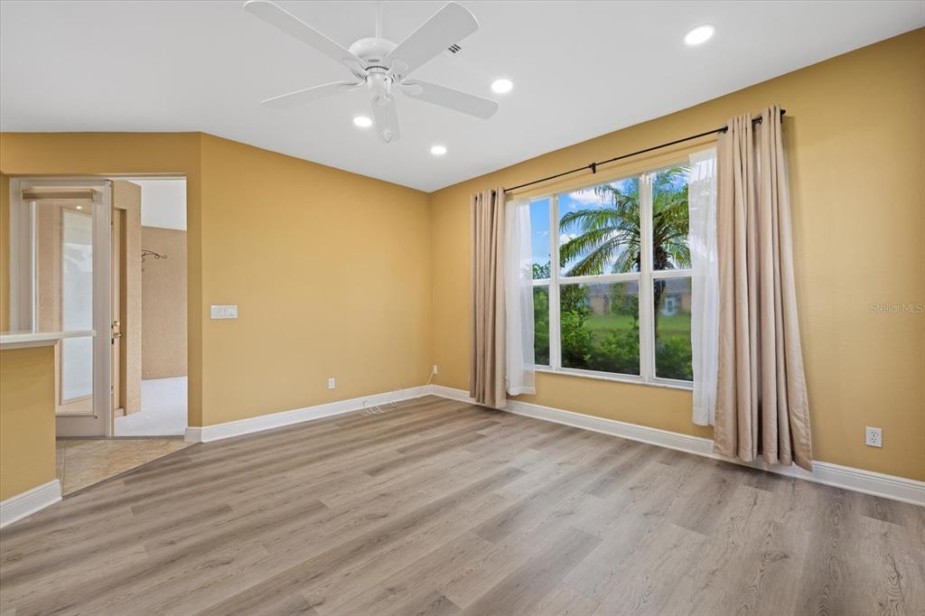 4331 Turnberry Circle North Port, FL 34288 - Photo 7 of 25 a view of an empty room with a window and wooden floor