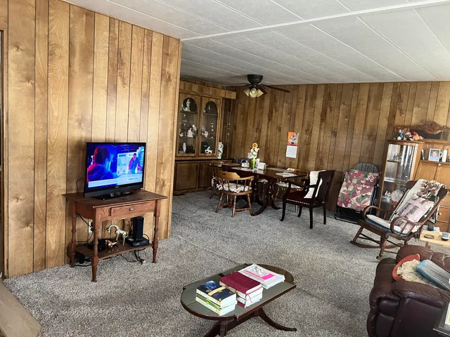 a view of a livingroom with furniture and a flat screen tv