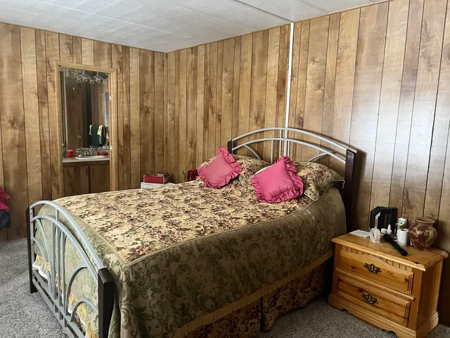 a bedroom with a bed and curtain