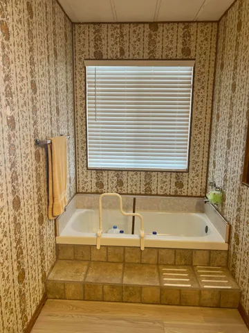 a bathroom with a bathtub and shower