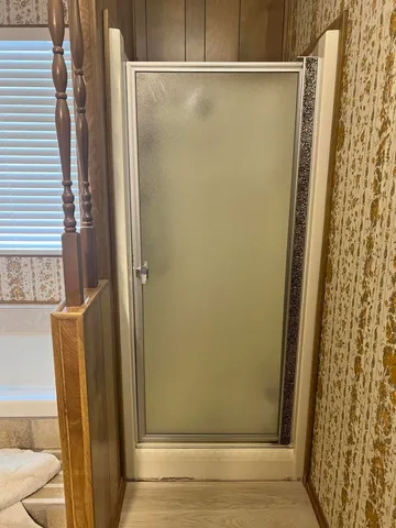 a bedroom with a bed and a table chair