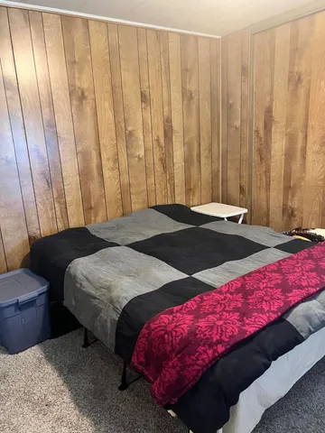 a bedroom with a bed and a closet