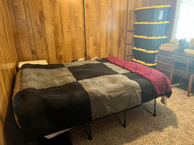 a bathroom with a granite countertop toilet a sink and a mirror
