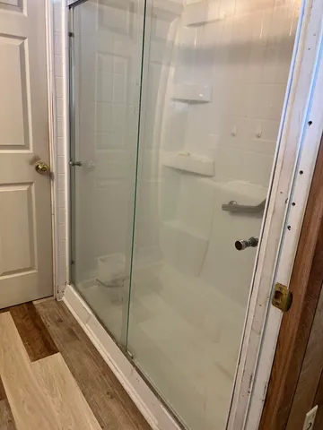 a utility room with dryer washer and a view of living room