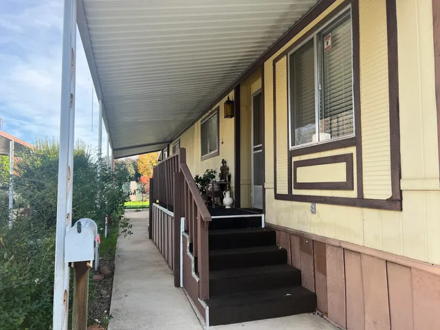 a view of a porch with wooden floor and stairs