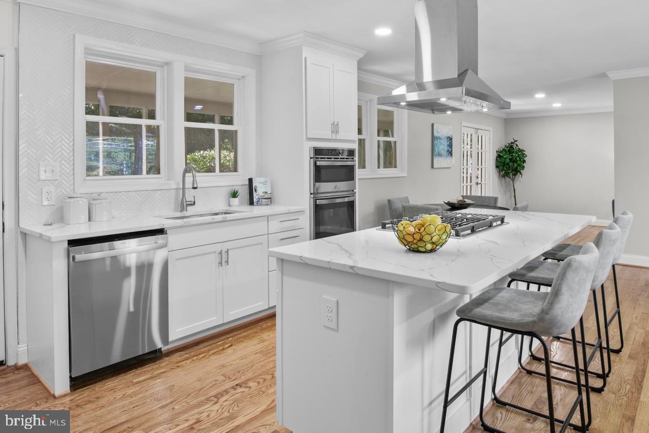 6502 Fort Hunt Road Alexandria, VA 22307 - Photo 11 of 44 a kitchen with a table chairs sink and cabinets
