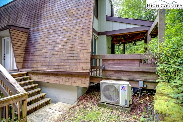a view of porch with a table and chairs