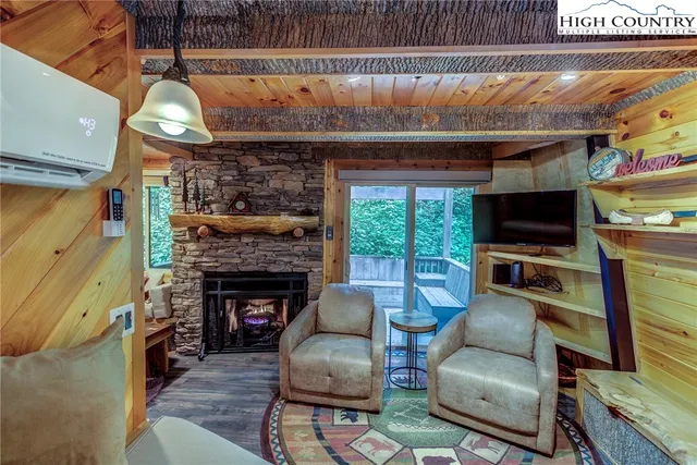 a living room with furniture a flat screen tv and a fireplace