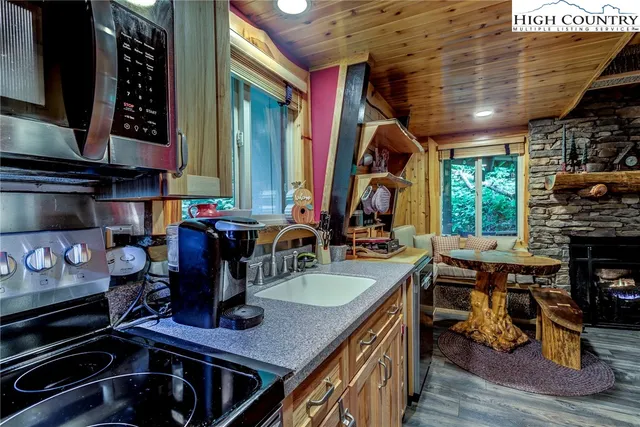 a kitchen with a stove and a wooden floor