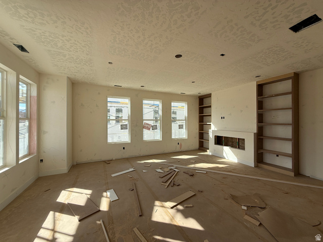 11021 South Freestone Road, Unit 121 South Jordan, UT 84009 - Photo 2 of 31 Spacious living area featuring multiple windows, recessed lighting, and a built-in fireplace with flanking custom shelving