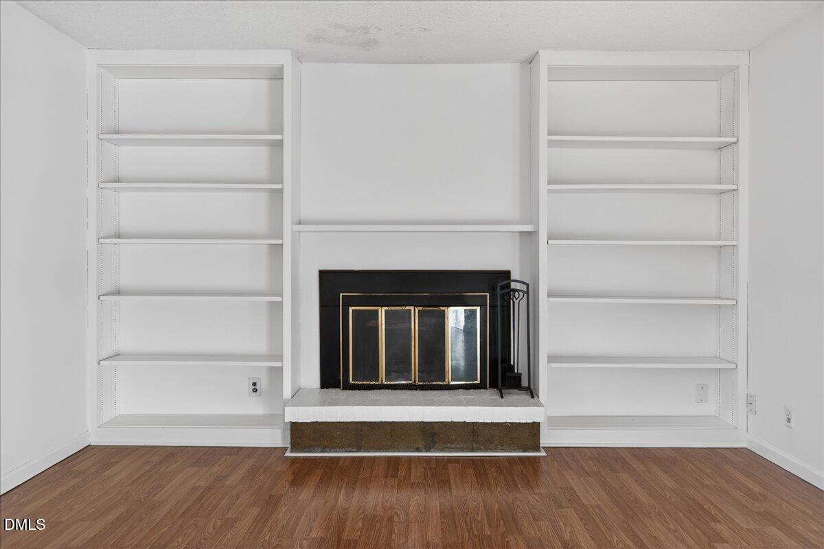 3088 Colony Road, Unit 3088D Durham, NC 27705 - Photo 13 of 25 a view of an empty room with a window and wooden floor