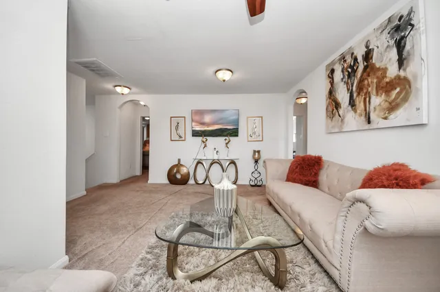 a living room with furniture and wooden floor
