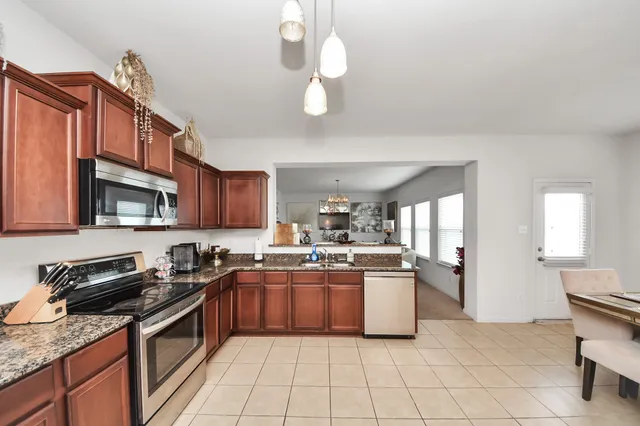 a kitchen with a sink window and cabinets