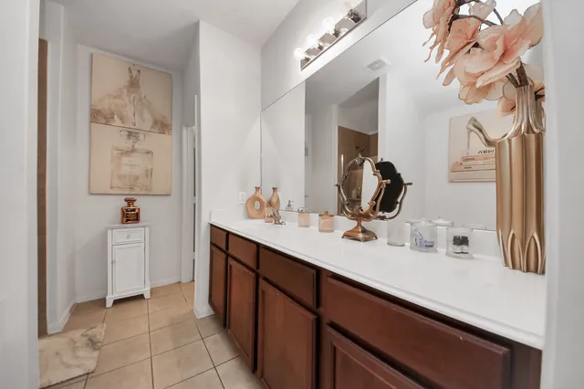 a bathroom with a double vanity sink a mirror and a bathtub