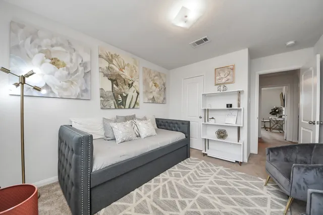 a living room with furniture and white walls