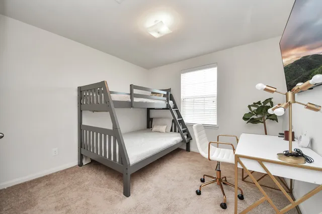 a bedroom with furniture and a window