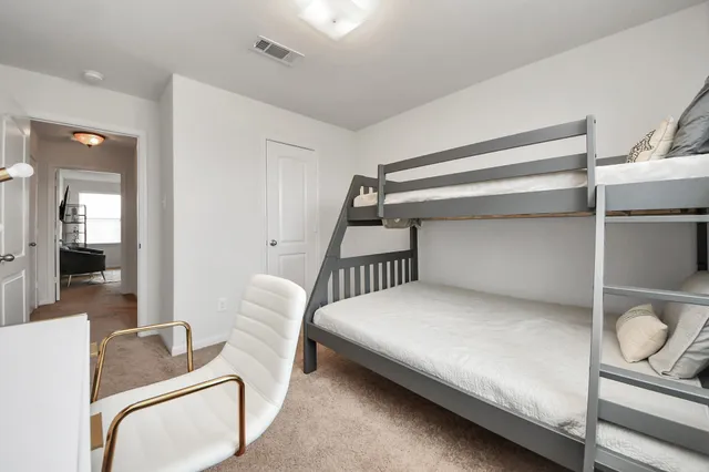 a bedroom with furniture and a window