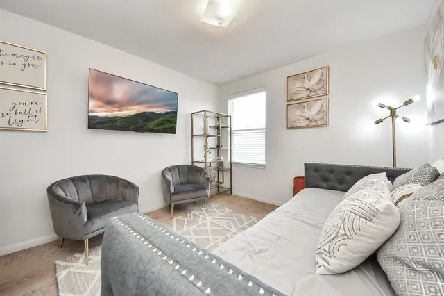 a living room with furniture and a chair