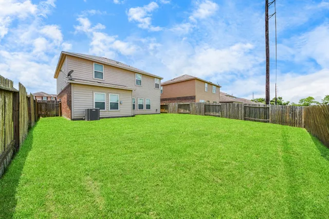 a view of a house with a yard and sitting area