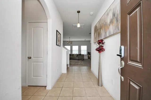 a view of a hallway and closet with windows