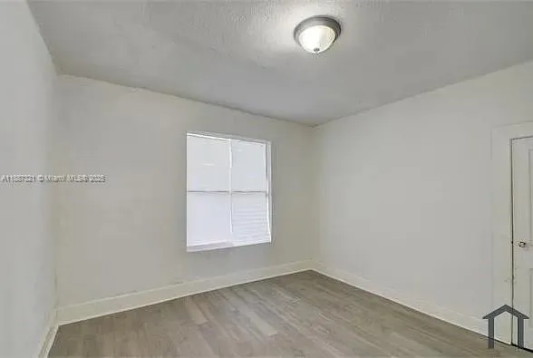 an empty room with closet area